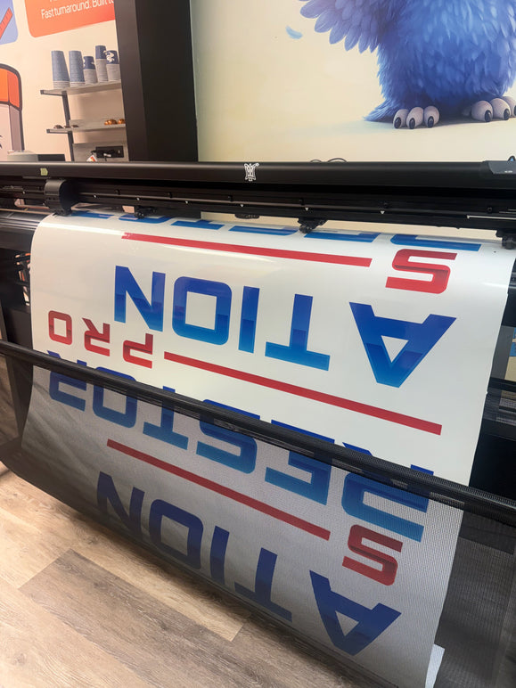 Freshly printed vehicle wrap panel coming off the press at Printwise