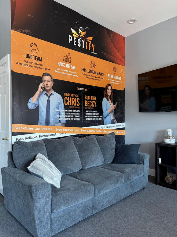Printed interior wall graphic covering a full office wall behind a seating area