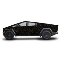 A side profile view of a Cybertruck-style pickup truck with a black wrap featuring a gold topographic contour line pattern, set against a plain white background.