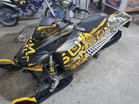 Ski-Doo snowmobile wrapped in a yellow and black printed vinyl graphic