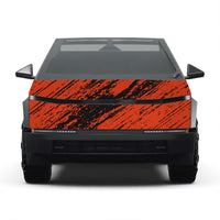 A front-facing view of a vehicle with a bold orange and black distressed brushstroke pattern on the hood, set against a plain white background.