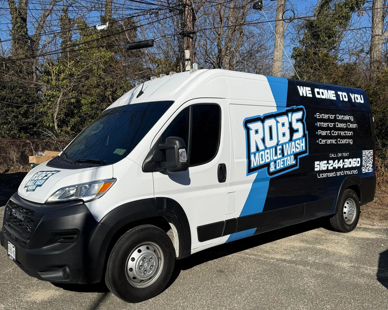 White van with blue and black commercial wrap